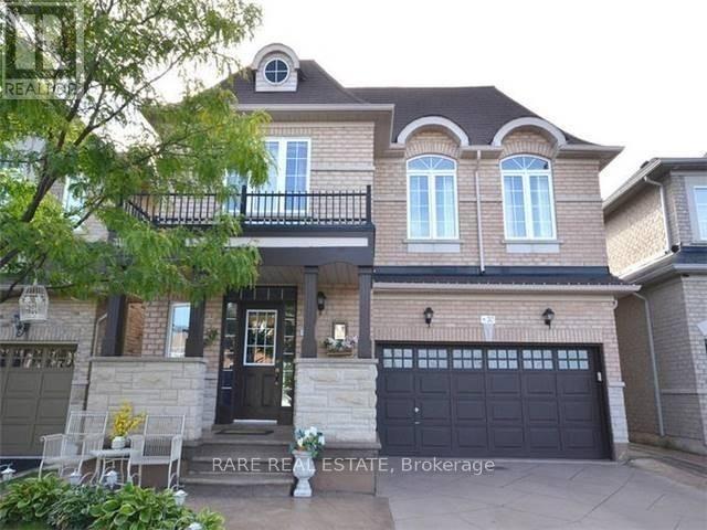 A two-story house with a balcony and a garage.