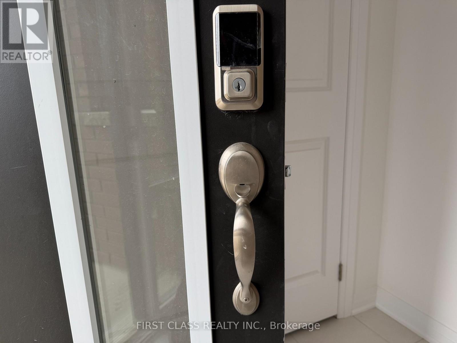 A door handle with a keypad and a keyhole.