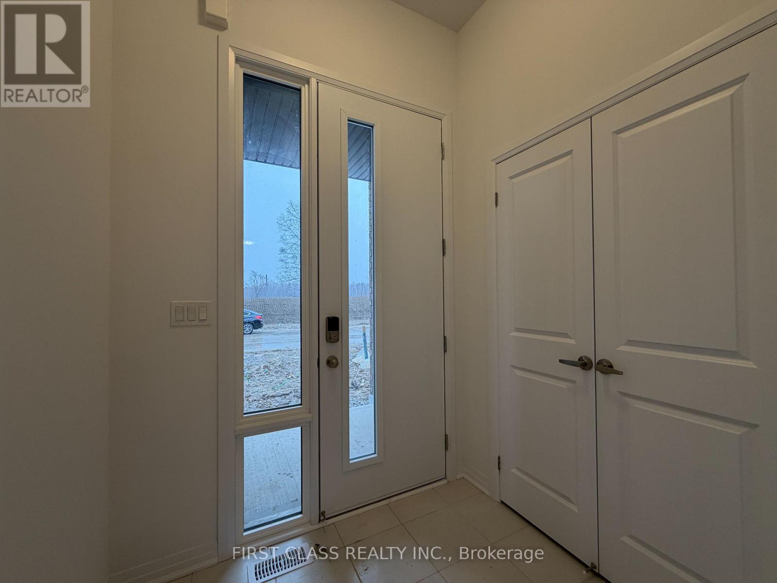 A room with a white door and a window showing a snowy landscape outside.