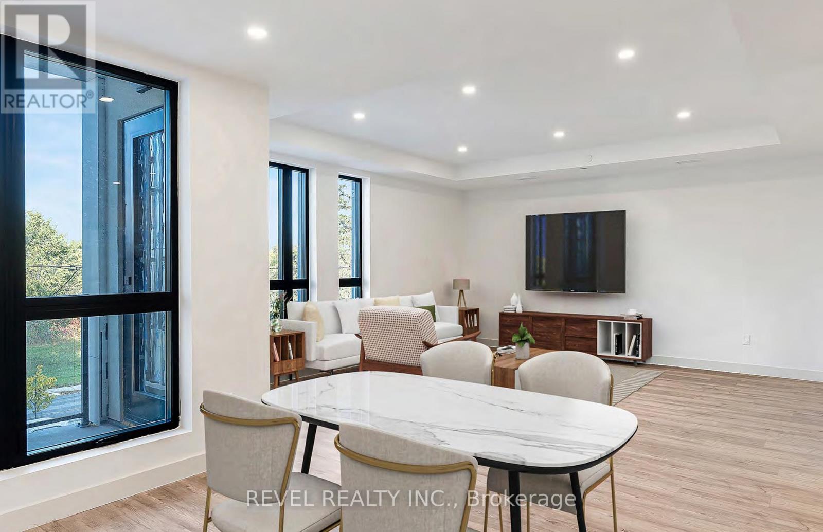A modern dining room with a glass table and chairs.