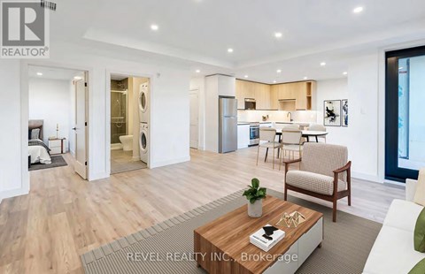 A modern living room with a wooden floor and a coffee table in the center.