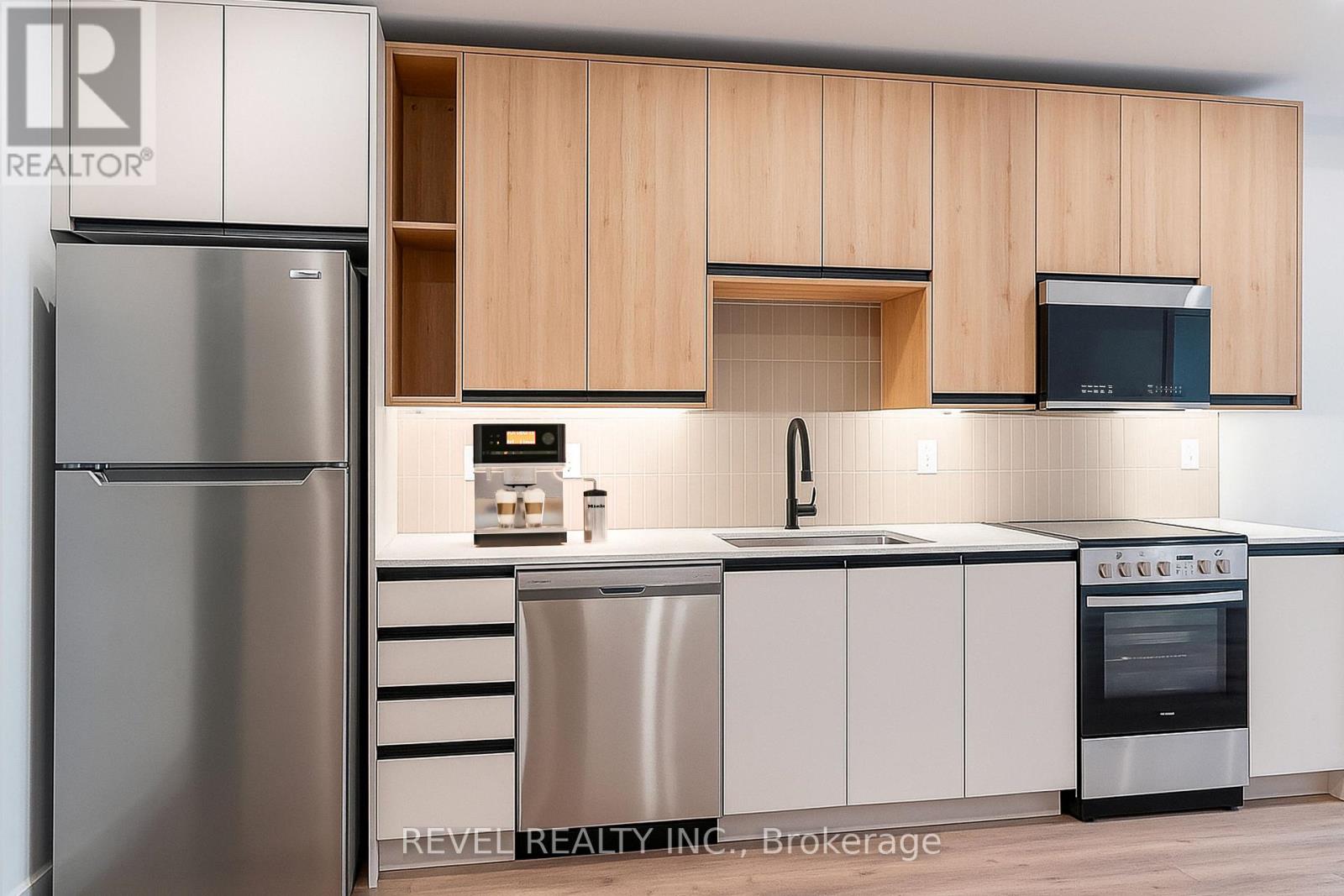 A modern kitchen with wooden cabinets and stainless steel appliances.