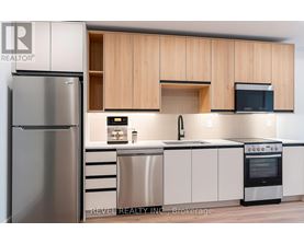 A modern kitchen with wooden cabinets and stainless steel appliances.