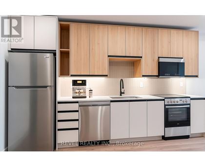 A modern kitchen with wooden cabinets and stainless steel appliances.