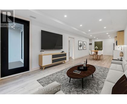 A modern living room with a flat screen TV and a coffee table in the center.