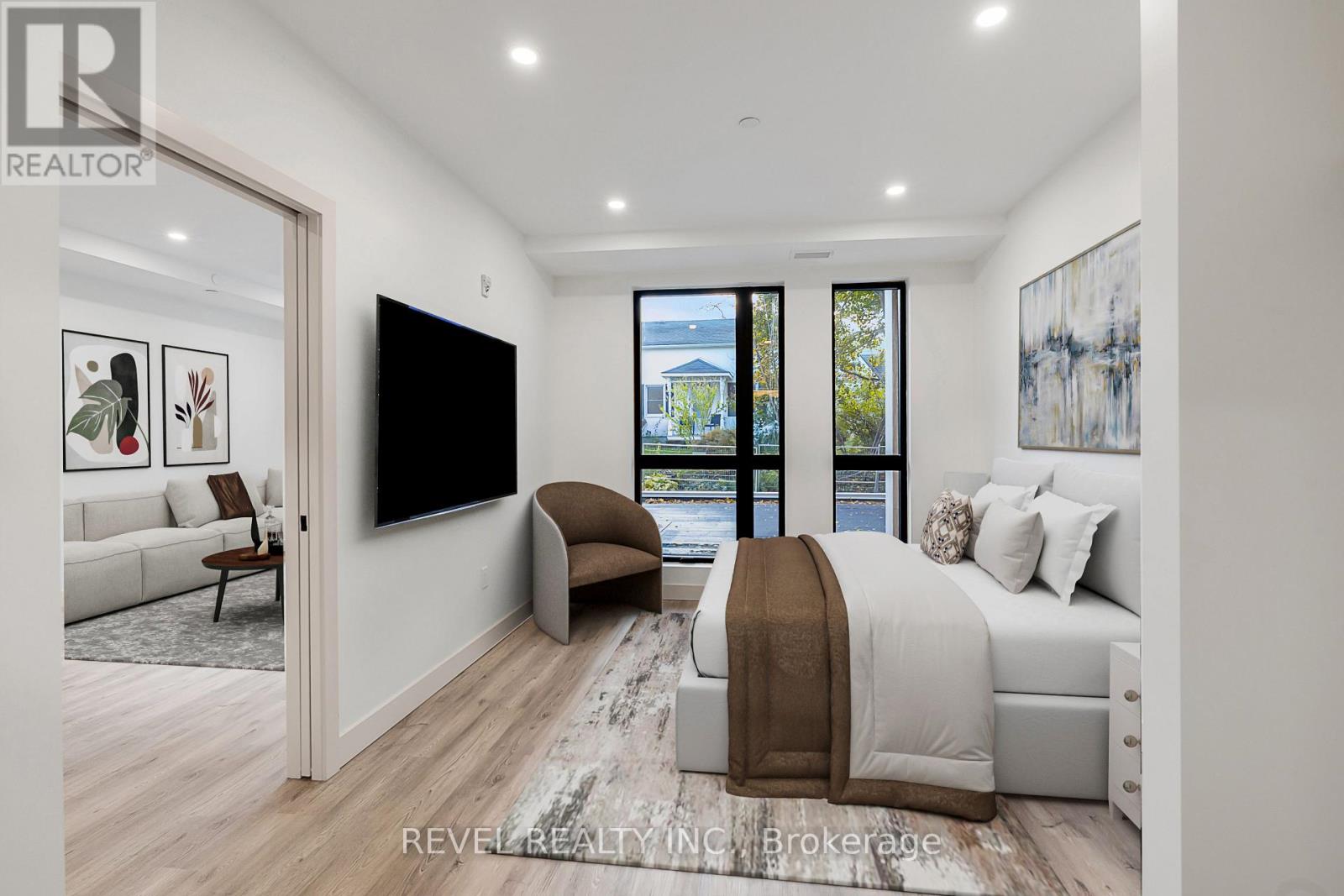 A bedroom with a large bed and a flat screen TV mounted on the wall.