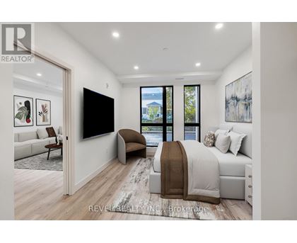A bedroom with a large bed and a flat screen TV mounted on the wall.