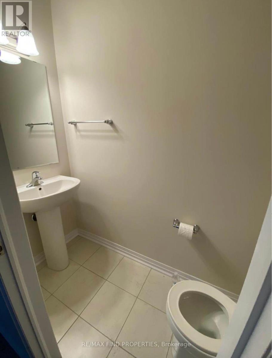 A white sink and toilet in a small bathroom.
