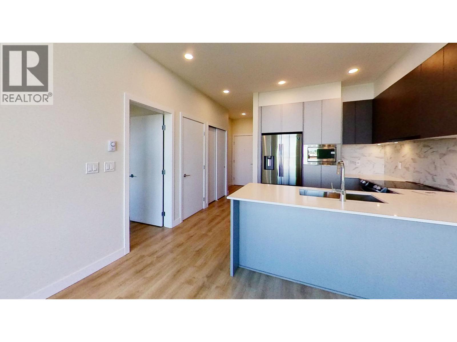 A realtor's office with a reception desk and a row of doors.