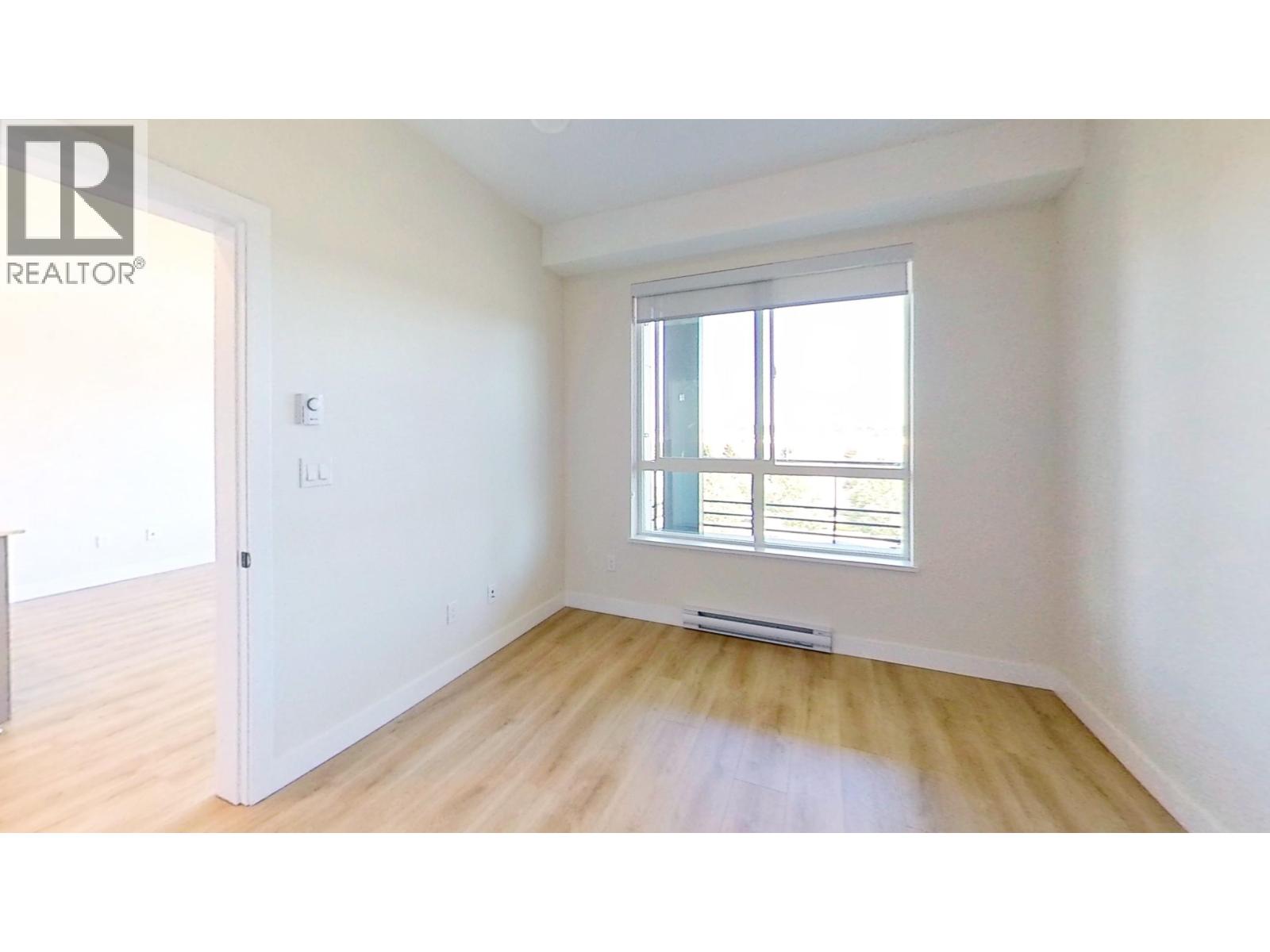 A room with a window and a door.