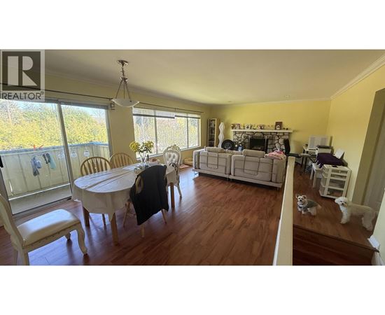 A living room with a dining table and chairs.
