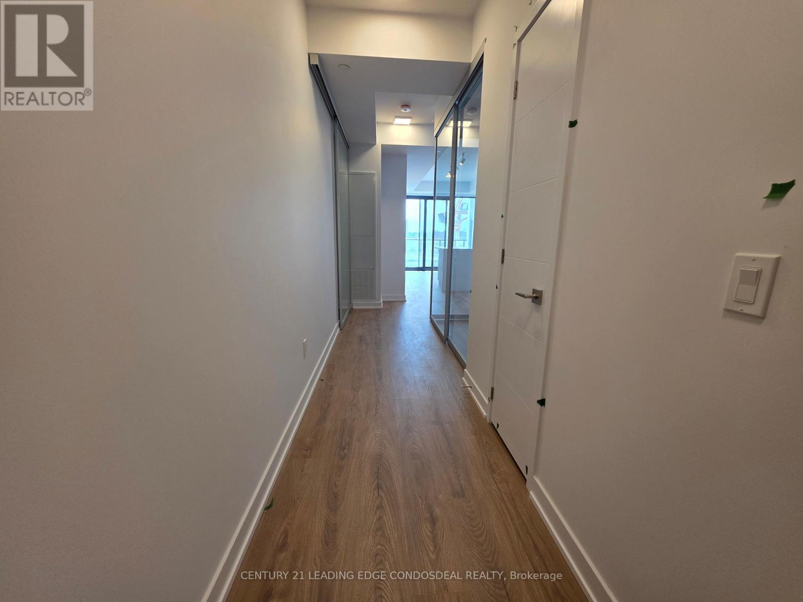 A long hallway with a door at the end.
