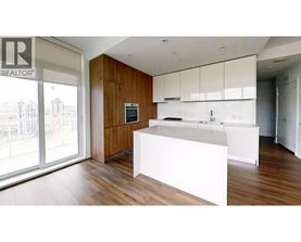 A modern kitchen with white countertops and wooden cabinets.