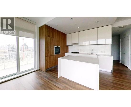 A modern kitchen with white countertops and wooden cabinets.
