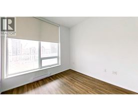 A room with a window and wooden floors.