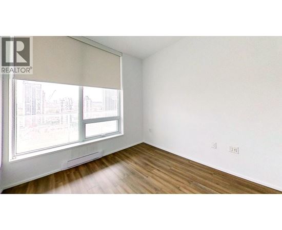 A room with a window and wooden floors.