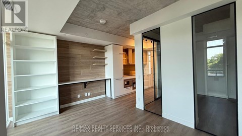 A modern kitchen with white cabinets and a wooden backsplash.