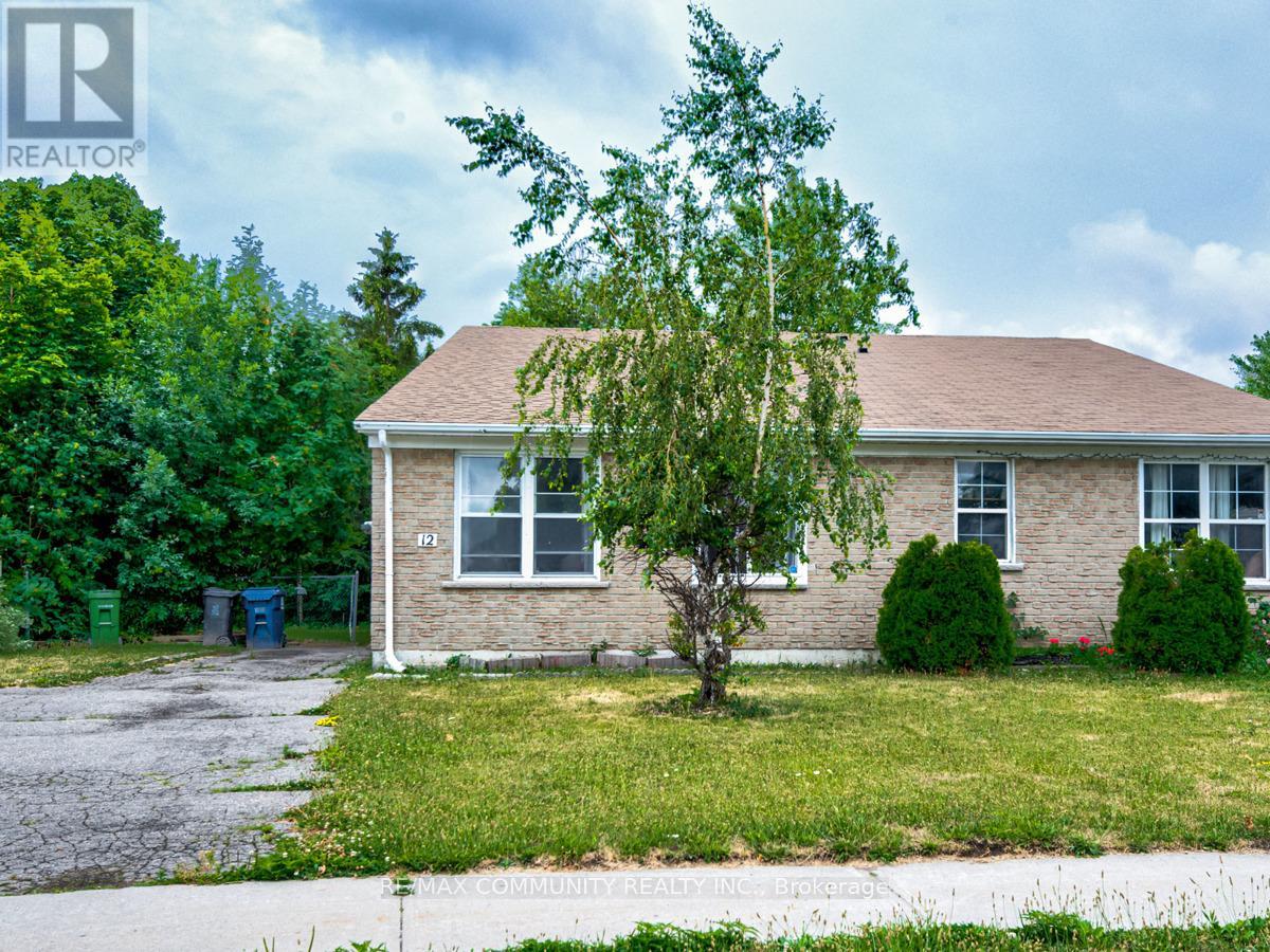 A house with a brown roof and a tree in front of it.