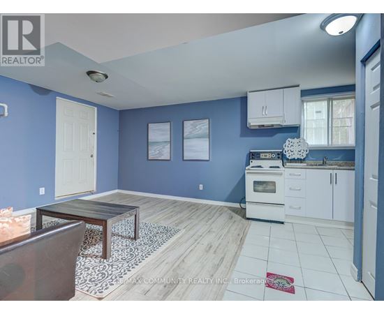 A kitchen with blue walls and white cabinets.