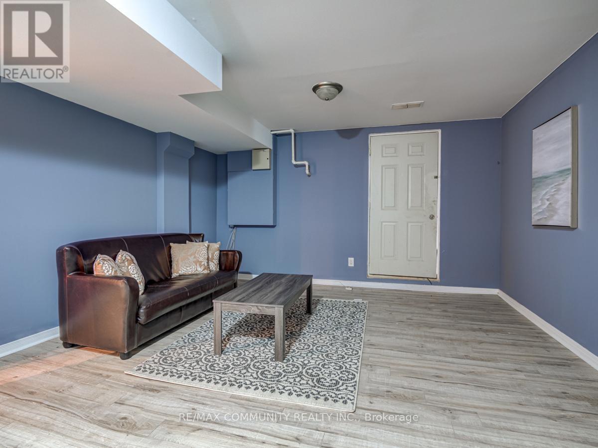 A living room with a brown leather couch and a coffee table.