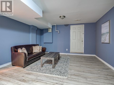 A living room with a brown leather couch and a coffee table.