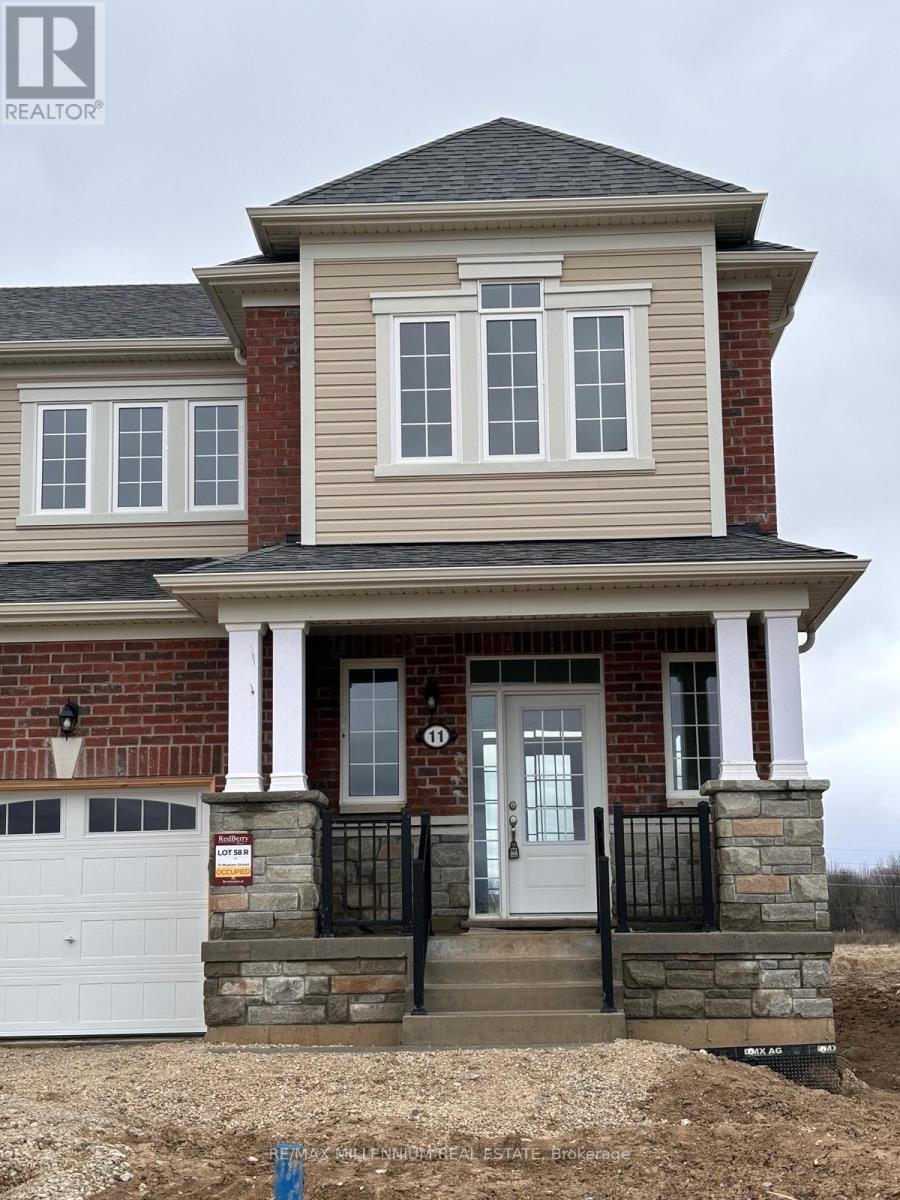 A two-story house with a brick facade and a white garage door.