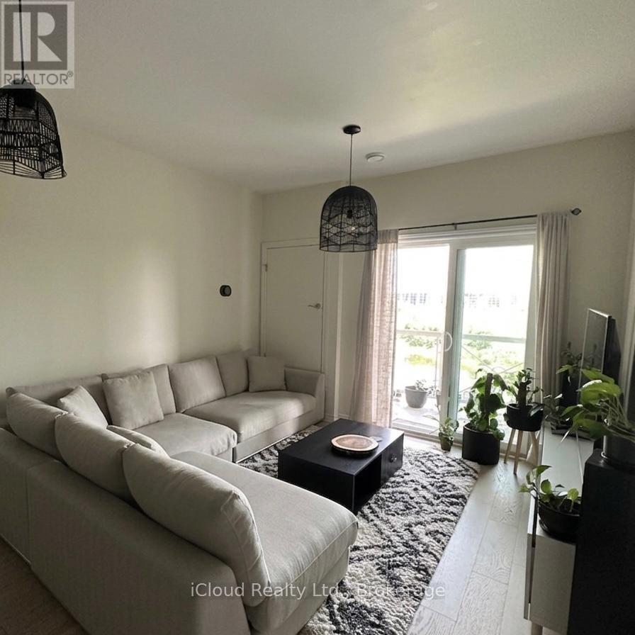 A living room with a grey sofa and a black coffee table.