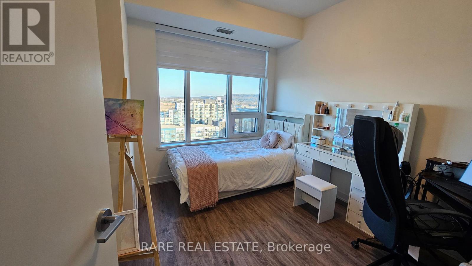 A bedroom with a bed, desk, and chair is on the market for $395K.