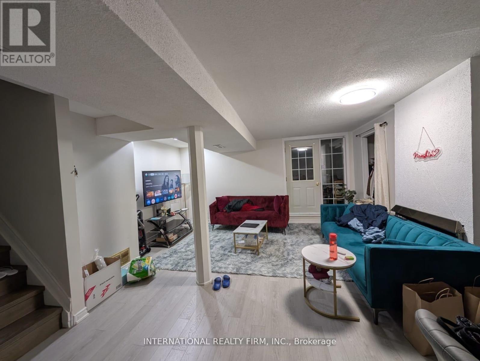 A living room with a couch, a television, and a coffee table.