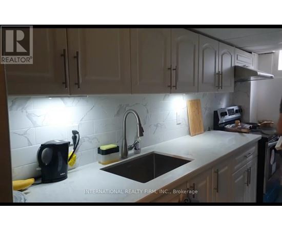 A kitchen with a sink, a coffee maker, and a cutting board.