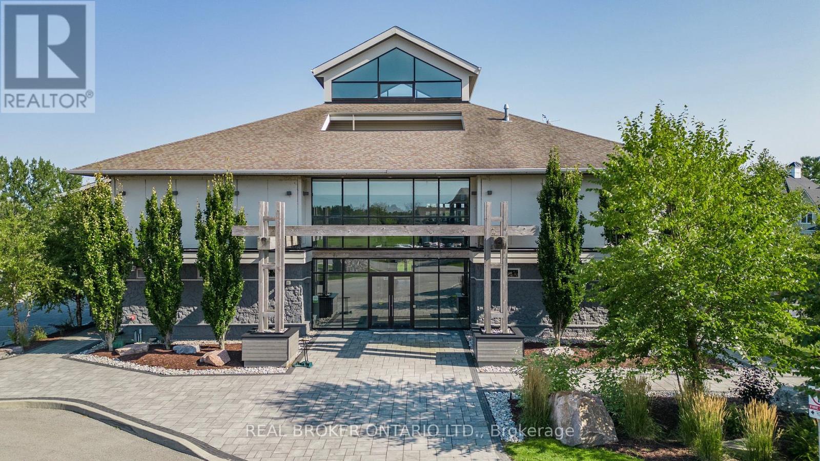 A large house with a stone entrance and a large glass window.