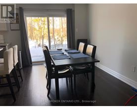 A dining room with a table and chairs is shown.