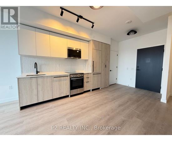A kitchen with wooden cabinets and a black oven.
