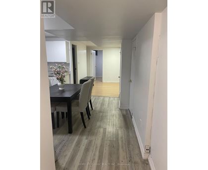 A dining room with a table and chairs.