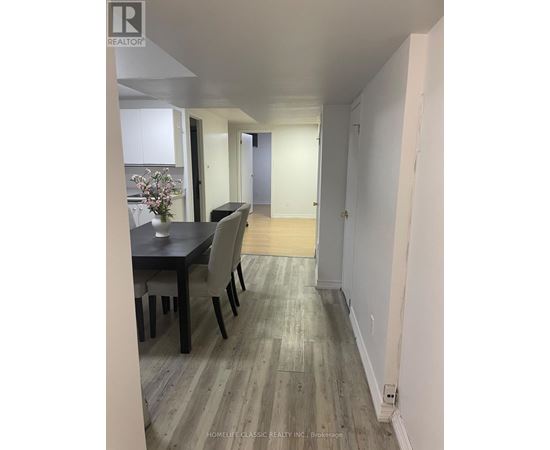 A dining room with a table and chairs.
