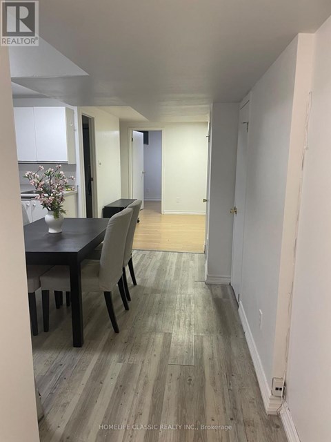 A dining room with a table and chairs.