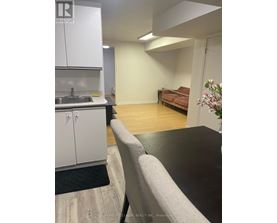 A kitchen area with a sink and cabinets.