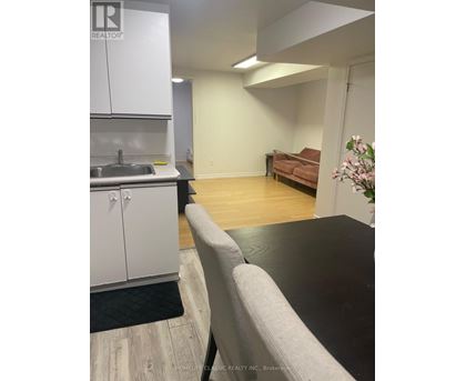 A kitchen area with a sink and cabinets.