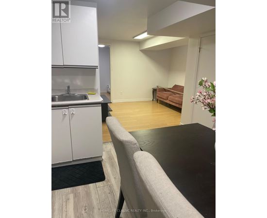 A kitchen area with a sink and cabinets.