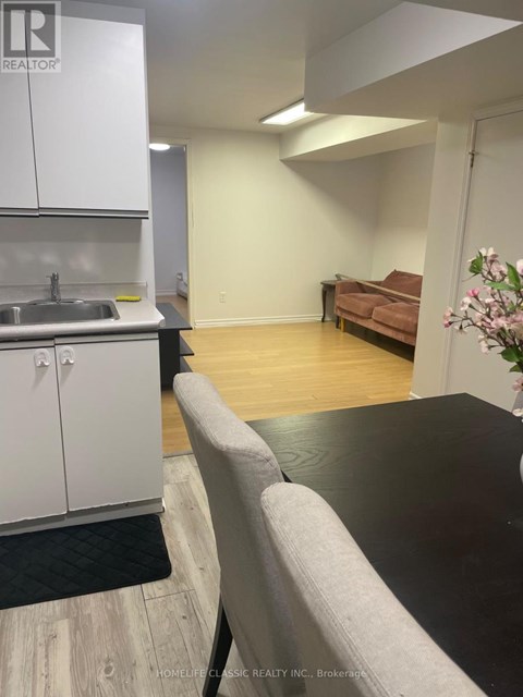 A kitchen area with a sink and cabinets.