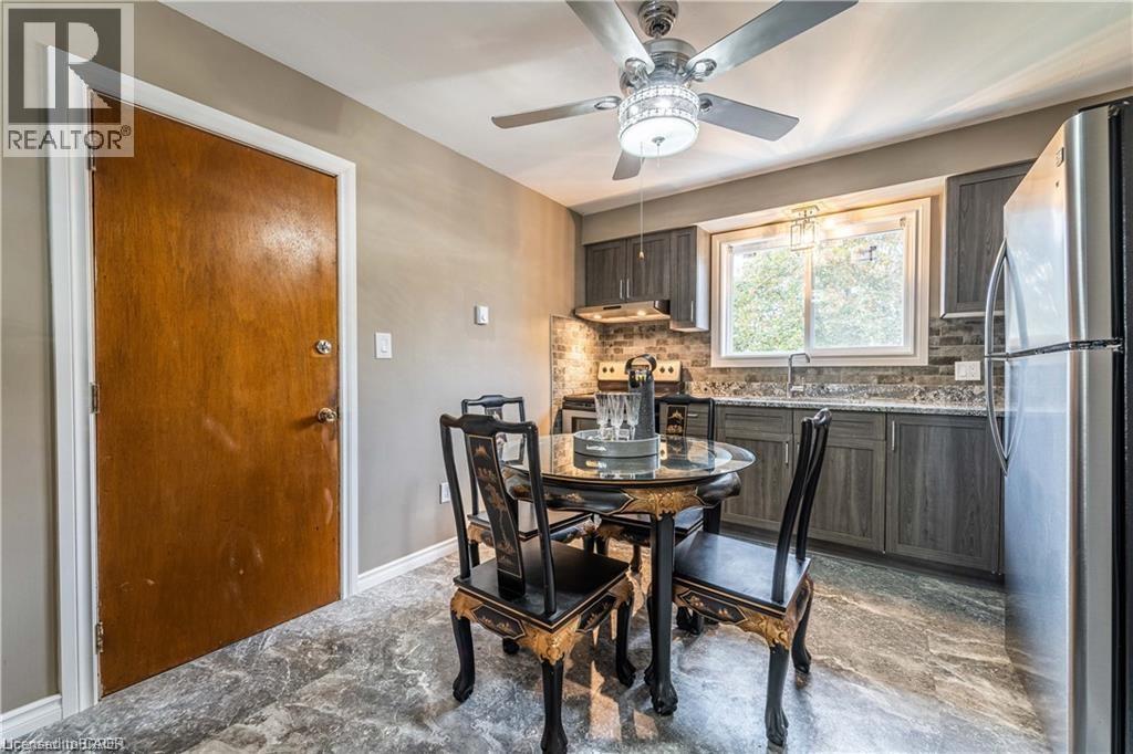 A dining room with a table set for four.