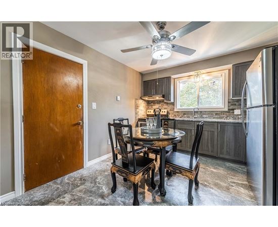 A dining room with a table set for four.