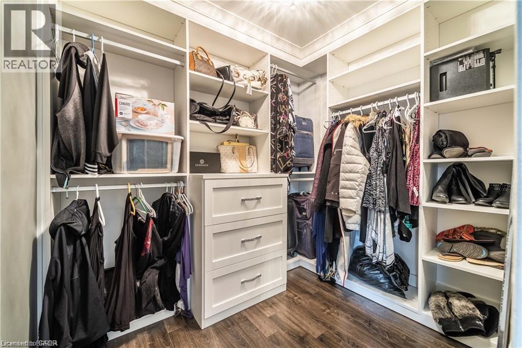A spacious walk-in closet with neatly organized clothes and shoes.