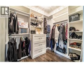 A spacious walk-in closet with neatly organized clothes and shoes.