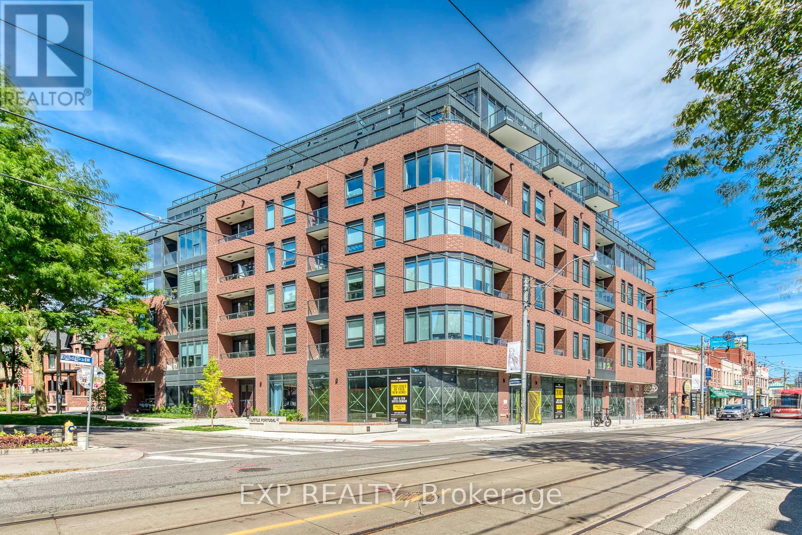A large red brick building with many windows is the main focus of the image.