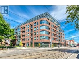 A large red brick building with many windows is the main focus of the image.