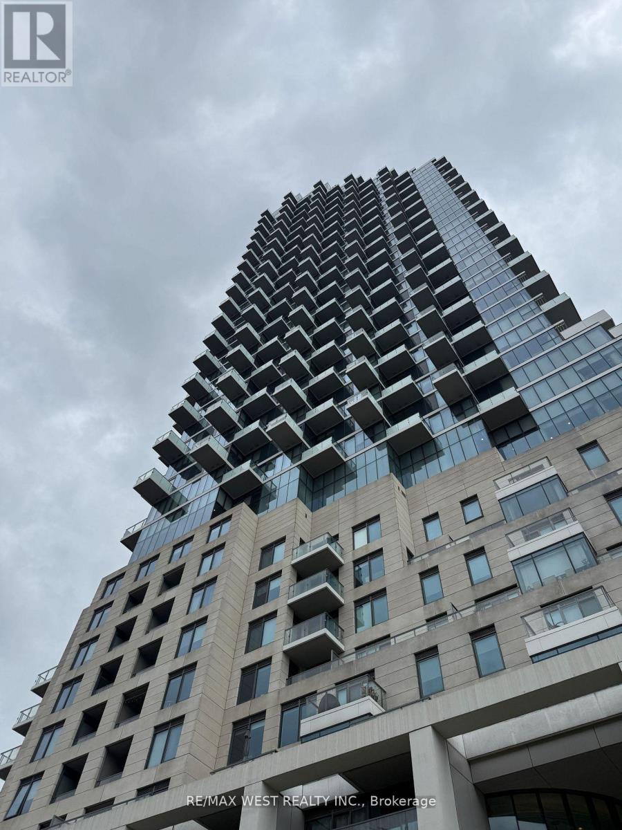 A tall building with a glass facade and a sign that reads "RE/MAX WEST REALTY INC., Brokerage".