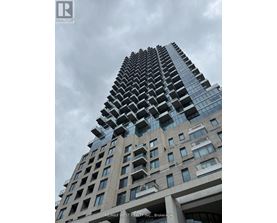 A tall building with a glass facade and a sign that reads "RE/MAX WEST REALTY INC., Brokerage".