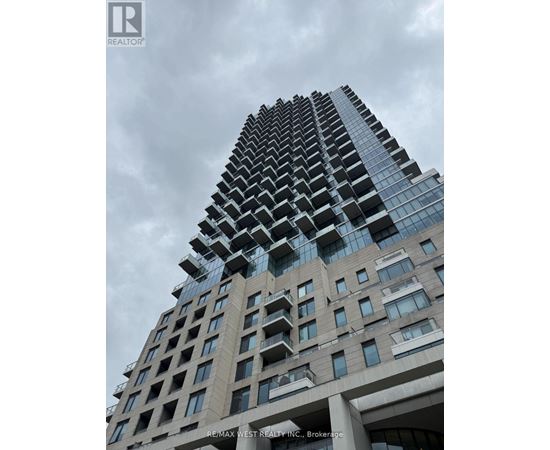 A tall building with a glass facade and a sign that reads "RE/MAX WEST REALTY INC., Brokerage".