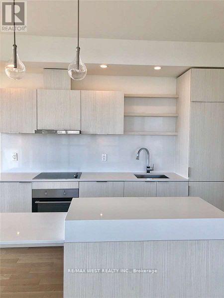 A modern kitchen with white cabinets and a center island.